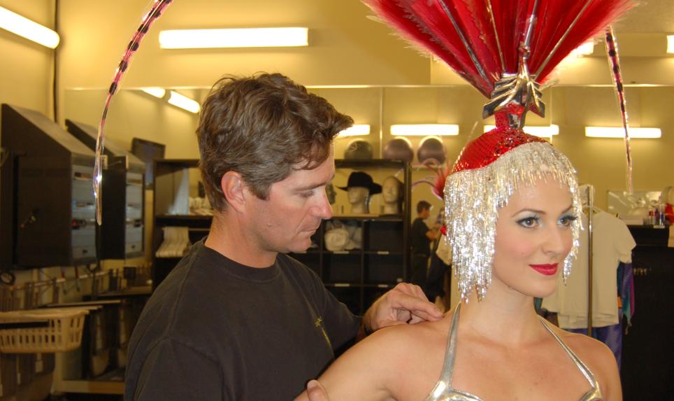 An athletic trainer who works in the performing arts helps a patient recover from an injury.